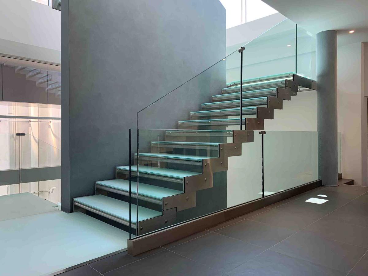 Scala interna in metallo con parapetto e gradini in vetro